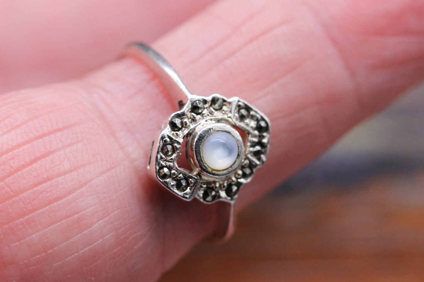 Lovely Silver Ring with central Moonstone and surrounded by dark marquisette stone