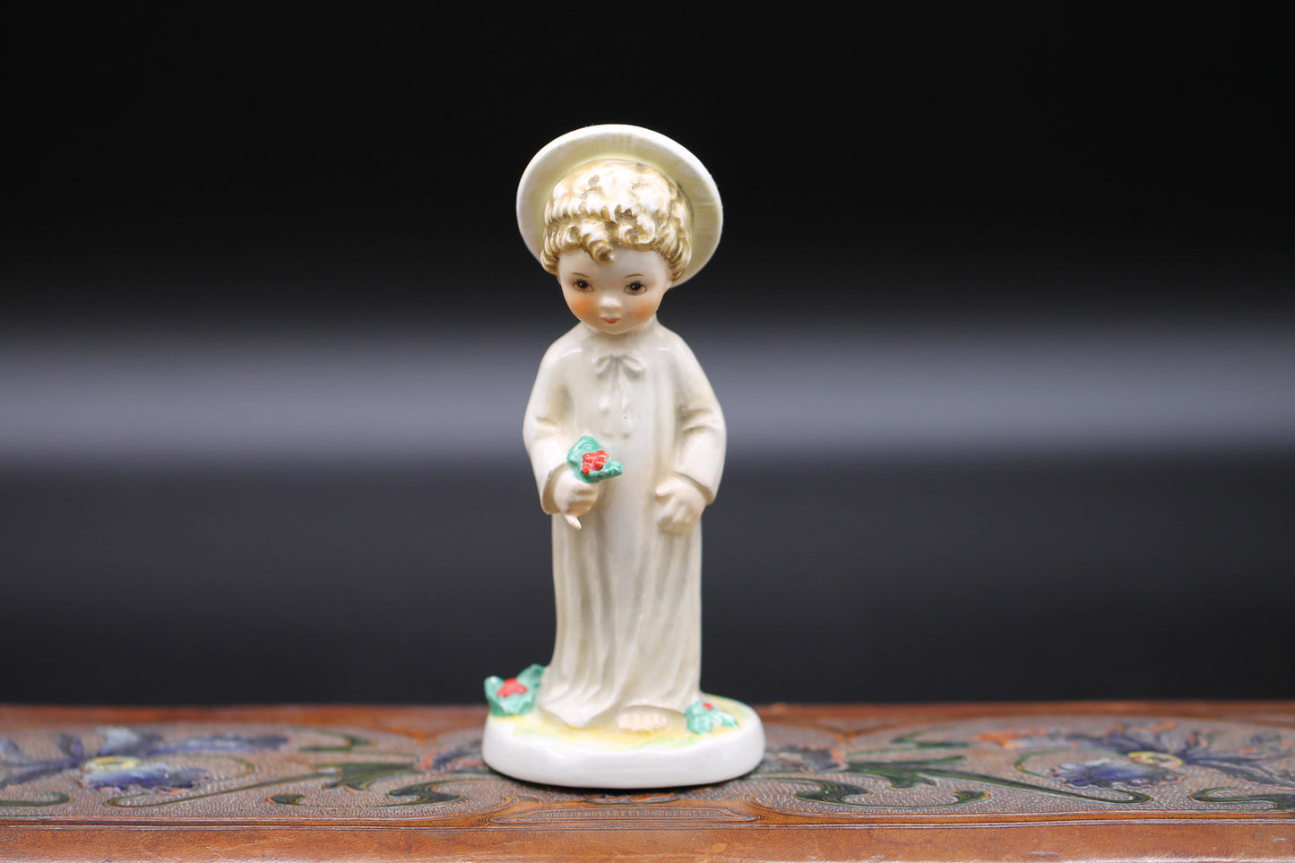 Vintage Christmas themed figurine of a young child in long smock with holly designed by Janet Robson Figurines by Goebel c1957