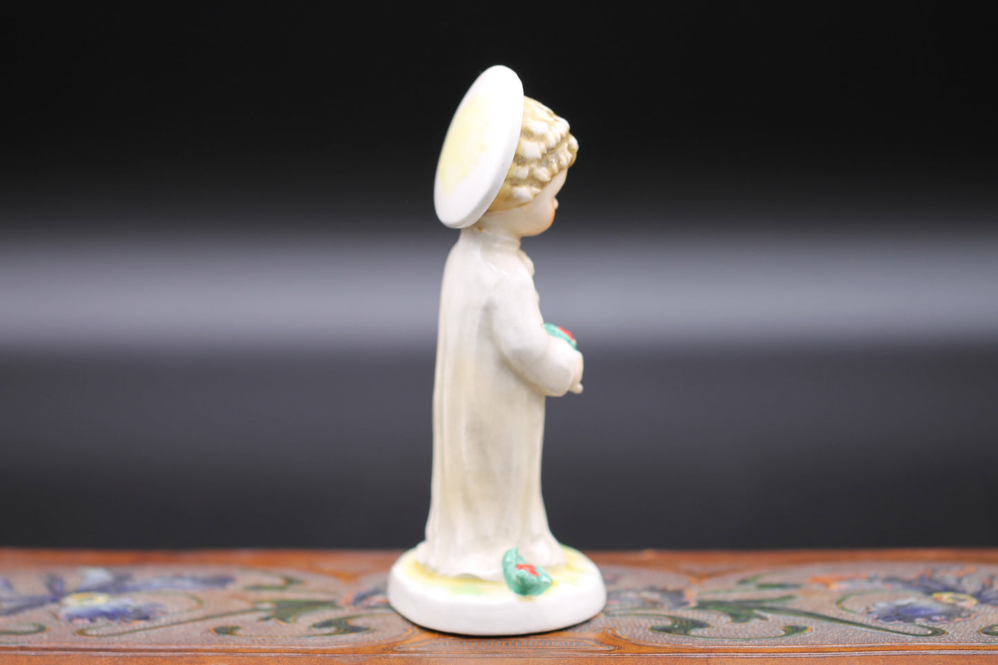 Vintage Christmas themed figurine of a young child in long smock with holly designed by Janet Robson Figurines by Goebel c1957