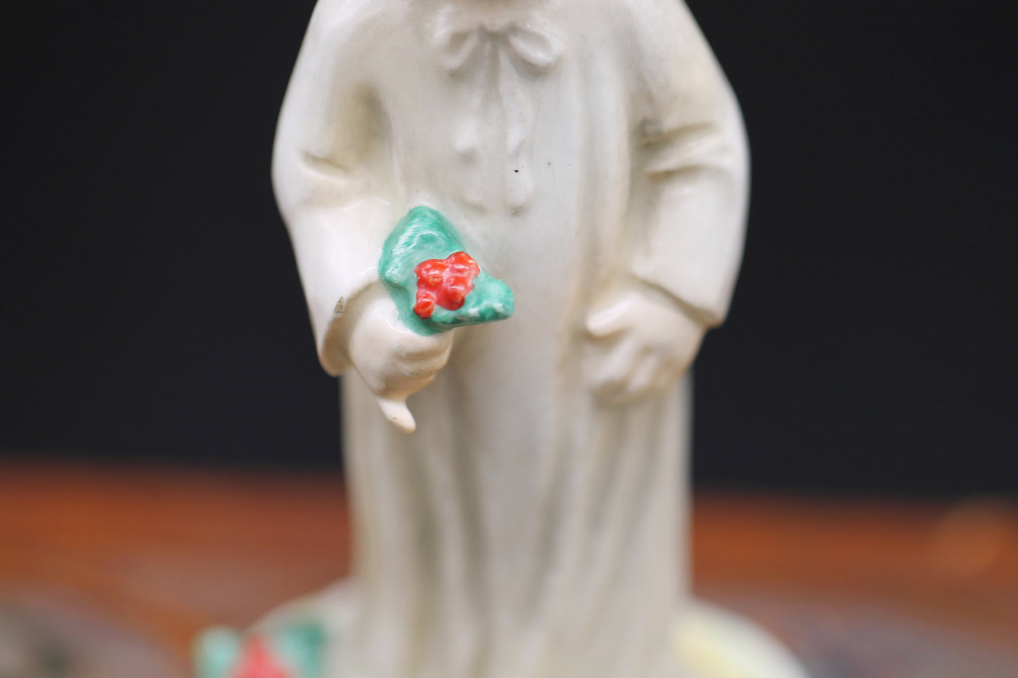 Vintage Christmas themed figurine of a young child in long smock with holly designed by Janet Robson Figurines by Goebel c1957