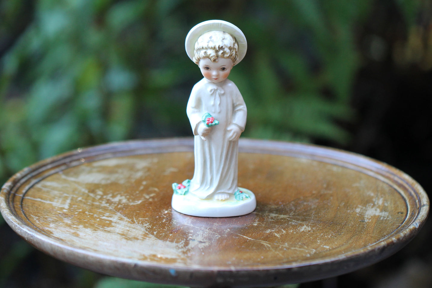 Vintage Christmas themed figurine of a young child in long smock with holly designed by Janet Robson Figurines by Goebel c1957