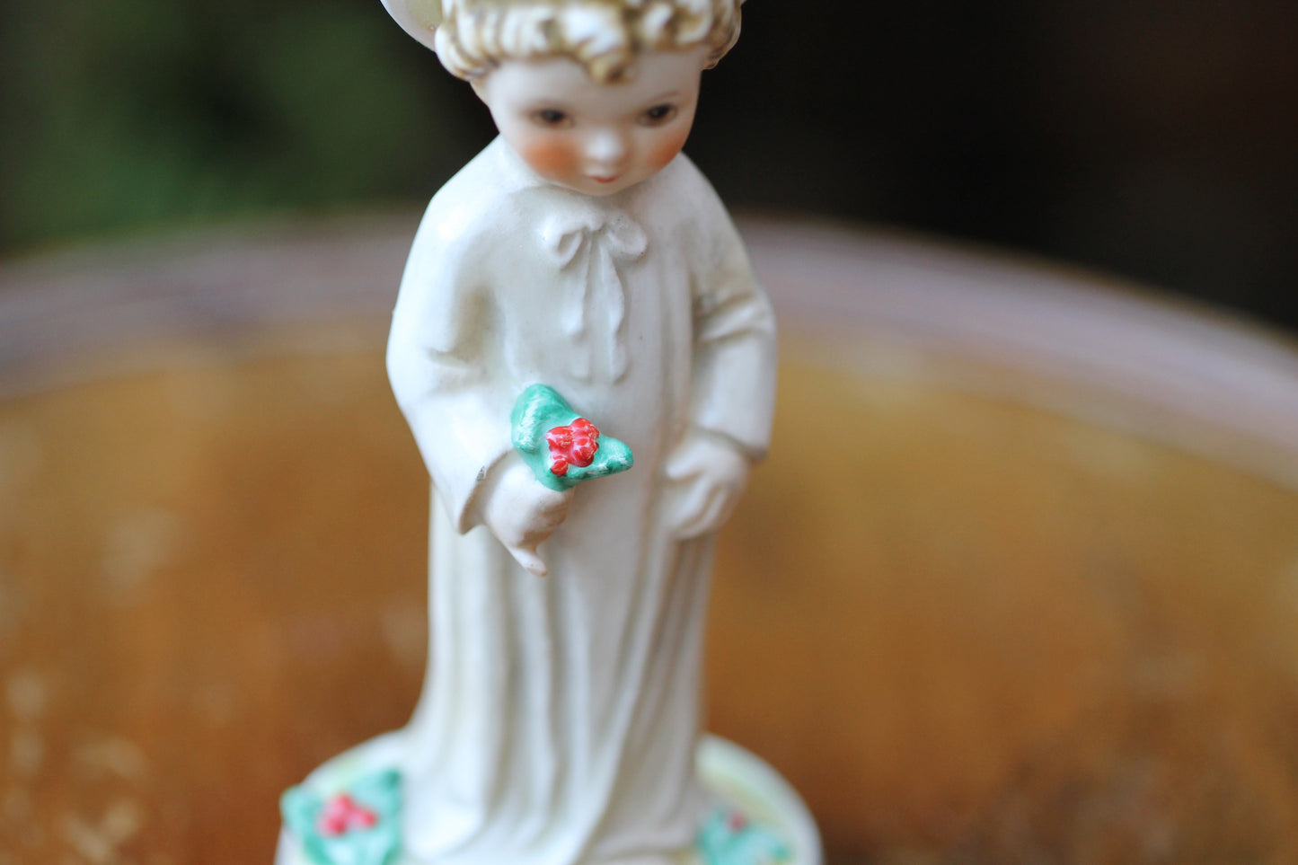 Vintage Christmas themed figurine of a young child in long smock with holly designed by Janet Robson Figurines by Goebel c1957