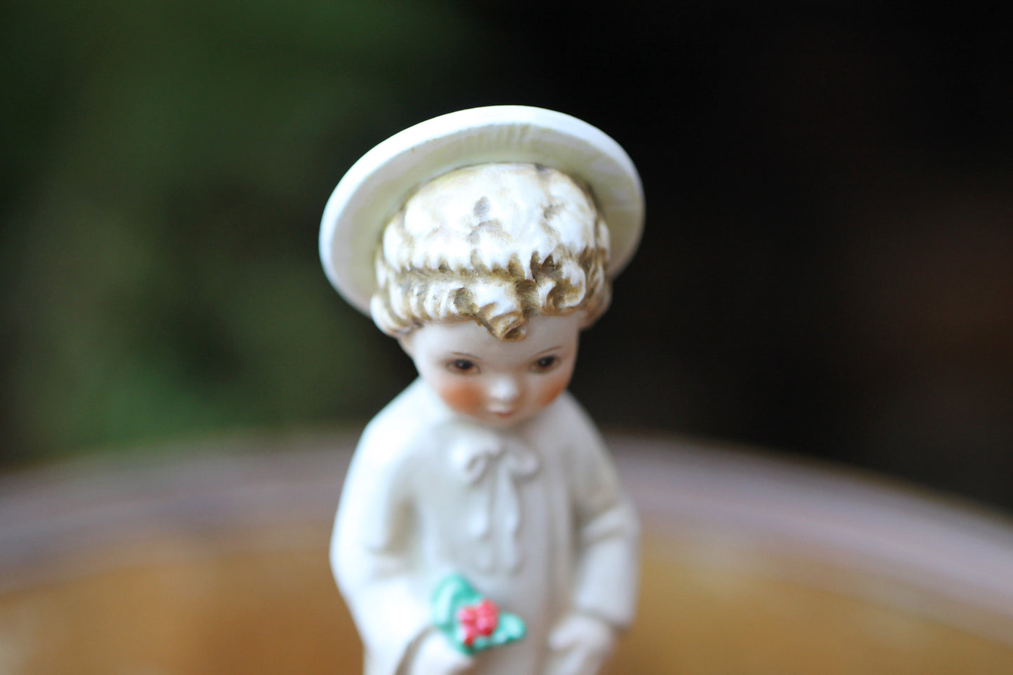 Vintage Christmas themed figurine of a young child in long smock with holly designed by Janet Robson Figurines by Goebel c1957