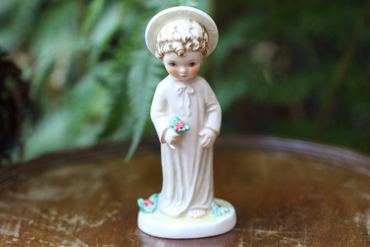 Vintage Christmas themed figurine of a young child in long smock with holly designed by Janet Robson Figurines by Goebel c1957